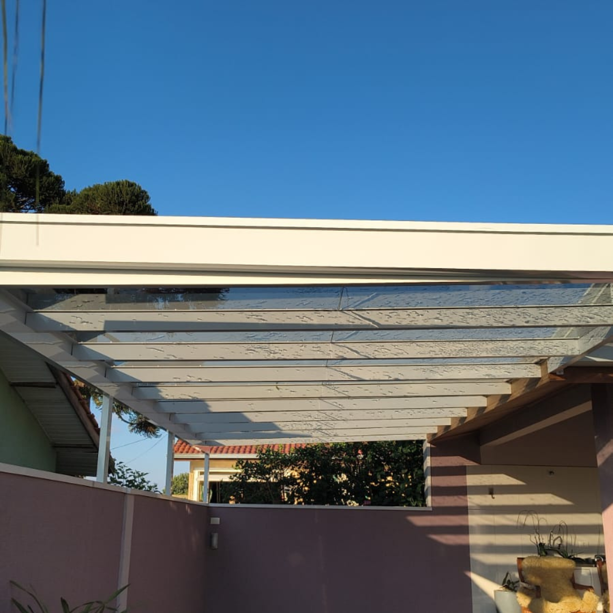 Cobertura em vidro ampla em área externa residencial